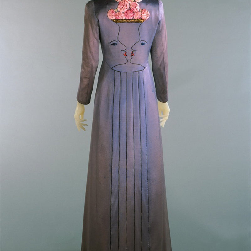 MANTEAU SCHIAPARELLI BRODÉ DE DEUX VISAGES EN TROMPE L’ŒIL ET ROSES SHOCKING